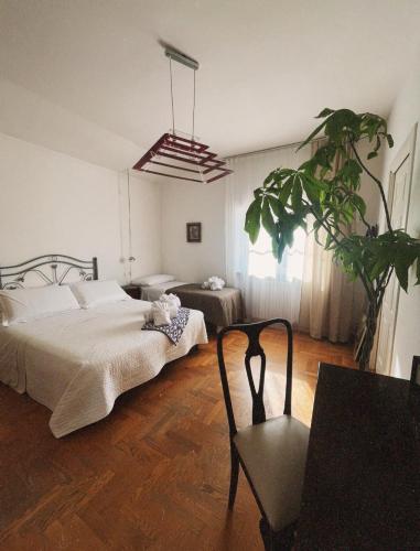 a bedroom with a bed and a potted plant at Villa Rosa in Torre del Greco
