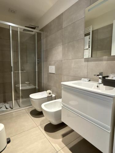 a bathroom with a toilet and a sink and a shower at Aparthotel Isola in Milan