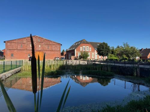 a reflection of a building in the water of a canal at Backhuus 2 in Fehmarn