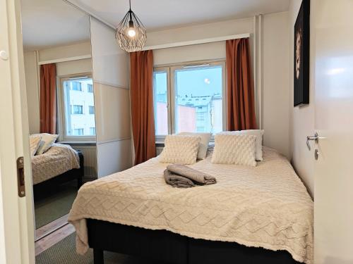 a bedroom with a bed and a window at Keskustan kolmio in Oulu