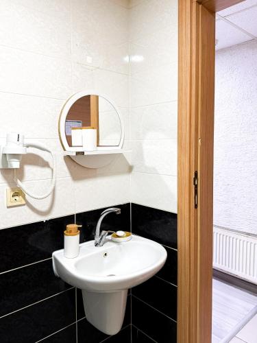 a bathroom with a white sink and a mirror at Avcılar İnci Hotel in Istanbul