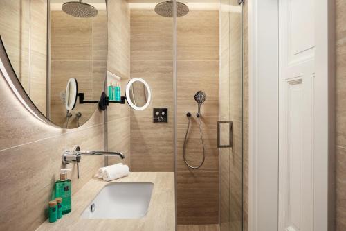 a bathroom with a sink and a shower at Six Residences Prague in Prague