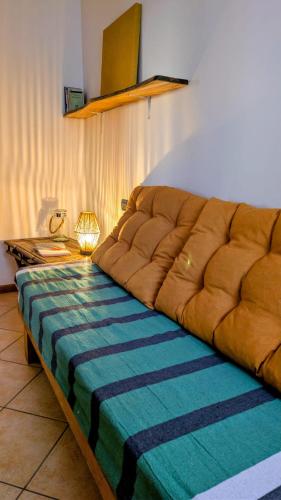 a large brown couch sitting in a living room at La casa di Lino in Volta Mantovana