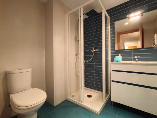 a bathroom with a toilet and a shower and a sink at Apartamentos La Aubaga in Valderrobres