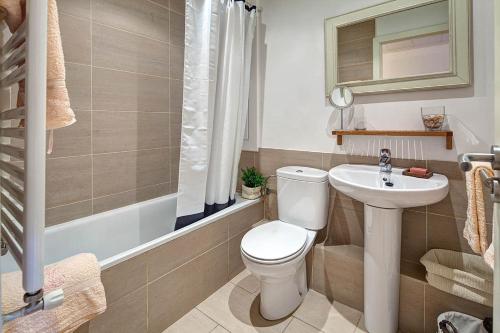 a bathroom with a toilet and a sink at Habitat Apartments Bruc Terrace in Barcelona