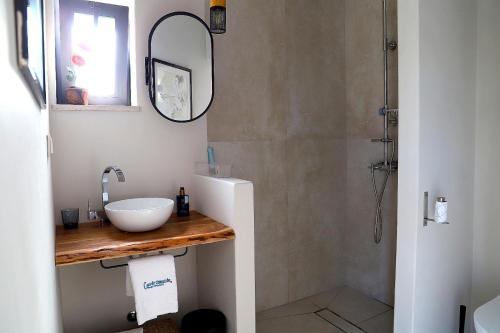 a bathroom with a sink and a shower at Casa do Campinho B&B boutique guest house in Reguengos de Monsaraz