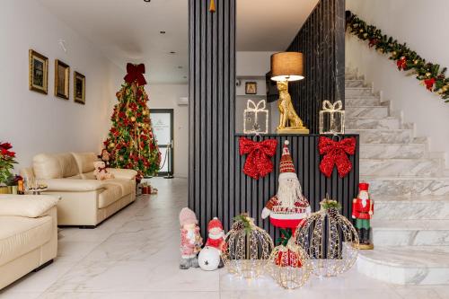 a living room with a christmas tree and christmas decorations at Hotel Boutique Tunari in Tunari