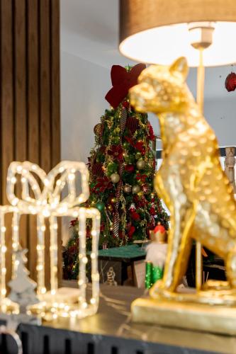 a figurine of a giraffe next to a christmas tree at Hotel Boutique Tunari in Tunari