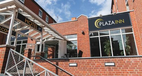 a pizzaarma restaurant with a sign on a brick building at PLAZA INN Grevenbroich in Grevenbroich