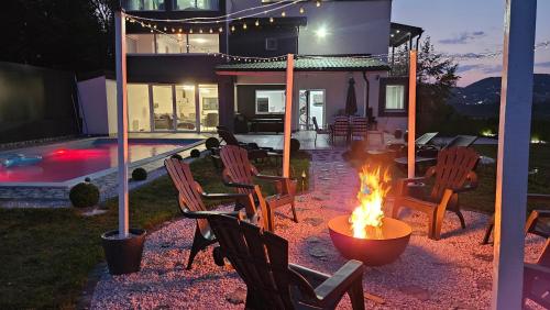a fire pit in a yard next to a house at Villa Kaplan Sarajevo in Gladno Polje
