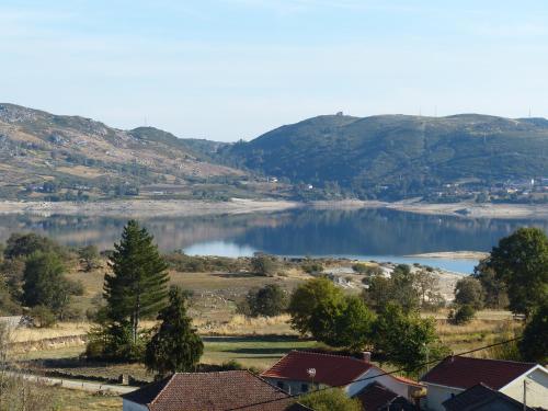 a view of a lake with houses and mountains at Casa do Alto Montalegre in Montalegre