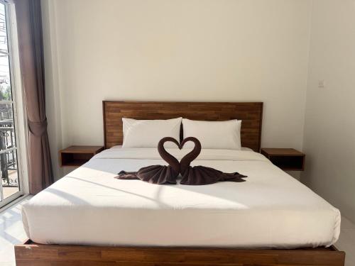 a bedroom with a bed with a heart decoration on it at Chailai room202 in Ban Sai Thai