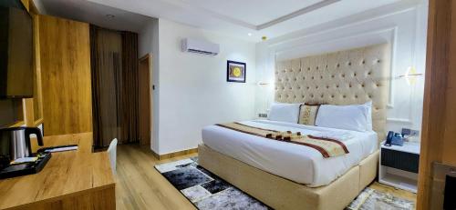 a bedroom with a large bed in a room at Cathelea Convention & Suites in Benin City