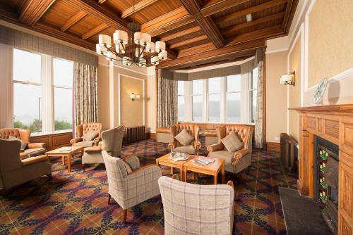 a large living room with couches and a fireplace at Loch Awe Hotel in Dalmally