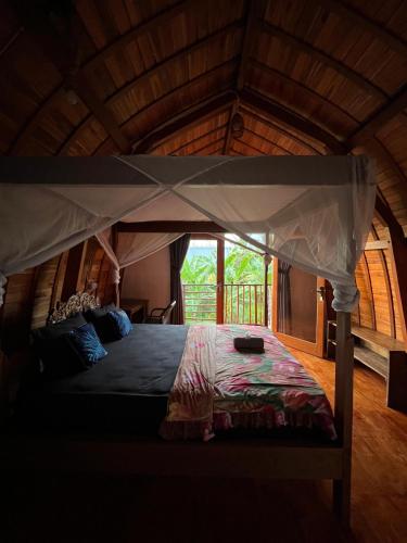 a bedroom with a bed in a wooden room at Ayolah surf House and Surfcamp in Jembrana