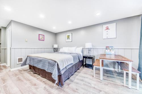 a bedroom with a bed and a table at Sea Treasures Inn Unit #212 in Rockaway Beach