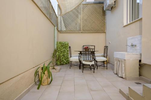 a patio with a table and chairs on it at Athenais Two Storey House in Zakynthos
