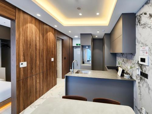 a kitchen with a sink and a counter at Paramion Hotel in Busan