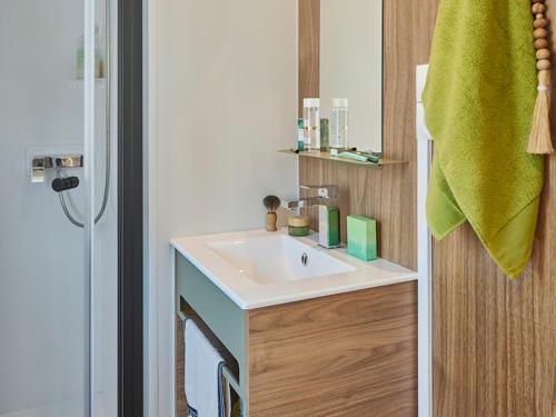 a bathroom with a sink and a mirror at Camping Le Damier in Pianottoli-Caldarello