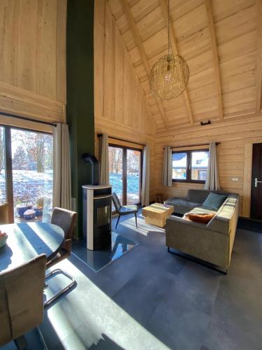 a living room with a couch and a table at Bosnest Nr 176 in Frankenau