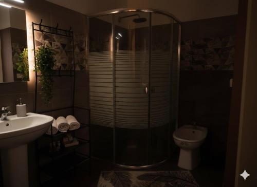 a bathroom with a shower and a sink and a toilet at Villa Mabrouka in Raʼs al Jabal