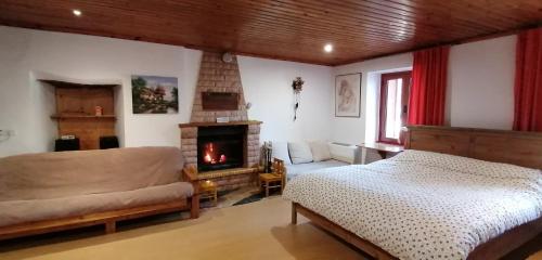 a bedroom with a bed and a fireplace at Adonis Guest House in Dimitsana
