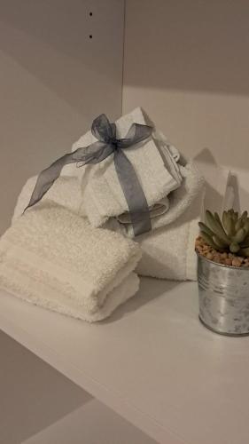 two towels with a bow sitting on a counter at Miro B&B in Lecce