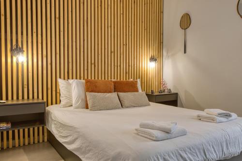 a bedroom with a large bed with towels on it at Stylish 1-Bedroom Apartment Just 5 Minutes from Valletta by Ferry in Mosta