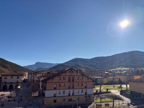 a view of a town with mountains in the background at Itxinako Balkoia in Murueta-Orozko