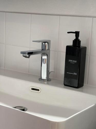 a bathroom sink with a faucet and a soap dispenser at Alpencabin Montafon in Vandans