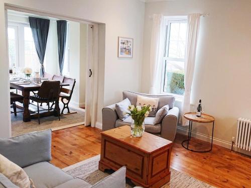 a living room with a couch and a table at 4 Bed in Bexhill-on-sea oc-77602 in Bexhill