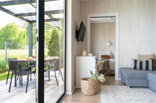 a living room with a table and a dining room at ZATORHOUSE in Zator