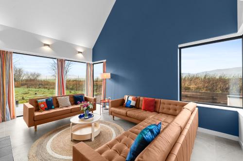 a living room with two couches and a blue wall at An Teallach in Balmullo