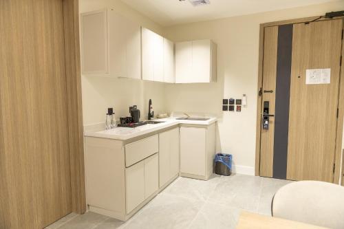 a kitchen with white cabinets and a sink at وساد الشمال للشقق الفندقية in Hail