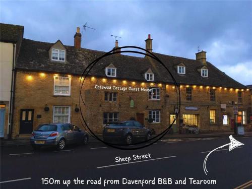 a building with a large metal circle on the side of it at Cotswold Cottage Guest House in Stow on the Wold
