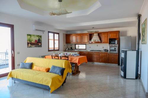 a kitchen and dining room with a table and chairs at House Gennauara in Lanusei