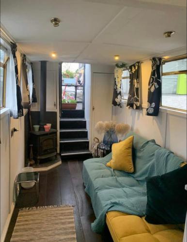 a living room with a couch in a tiny house at Narrow Boat moored in London in London