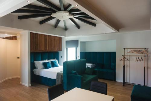 a bedroom with a bed and a ceiling fan at Os Ninhos dos Avôs in Ponta Delgada