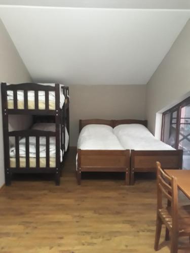 a bedroom with two bunk beds and a table at Villa Bakuriani hotel in Bakuriani