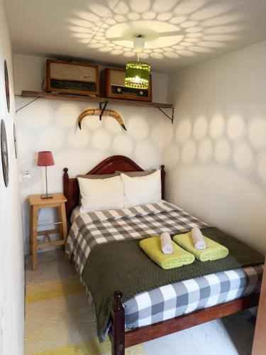 a bedroom with a bed with two towels on it at Casa Vintage Seixal Madeira in Seixal