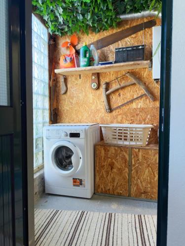 a washer and dryer in a tiny house at Casa Vintage Seixal Madeira in Seixal