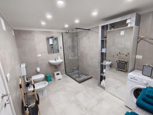 a bathroom with a shower and a sink and a toilet at Dimora Pietra e Mare Trani in Trani