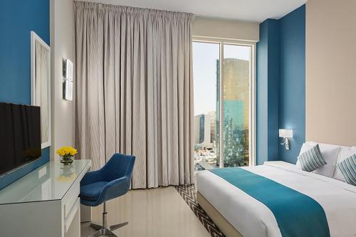 Awfad Hotel في الرياض: غرفة فندقية بسرير ونافذة كبيرة