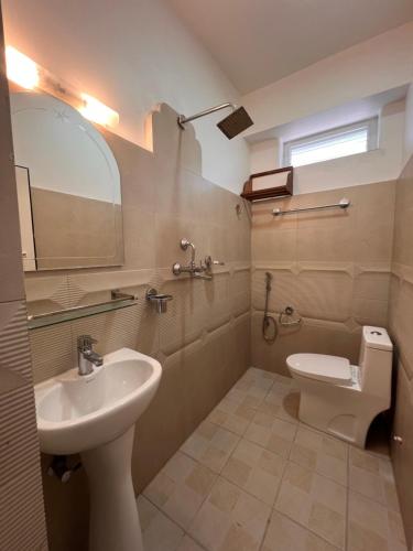 a bathroom with a sink and a toilet at Hotel Kandara in Pokhara