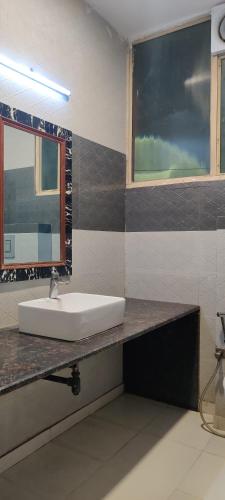 a bathroom with a sink and a window at Hotel Orchid Garden Karol Bagh in New Delhi