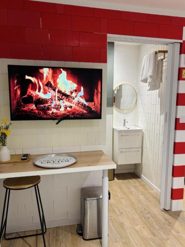 a fireplace in a bathroom with a counter and a table at Le cozy Cathedral Reims in Reims