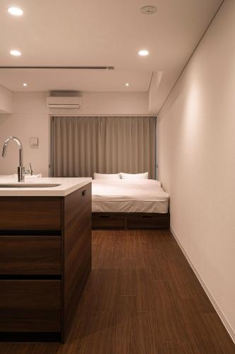 a bathroom with a sink and a bed in a room at Cava House - Vacation STAY 07286v in Tokyo