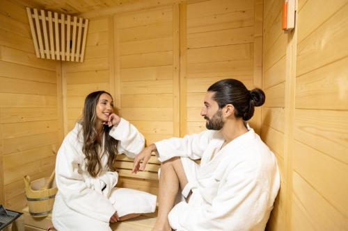 a man and a woman sitting in a sauna at Villa Almy in Plaka