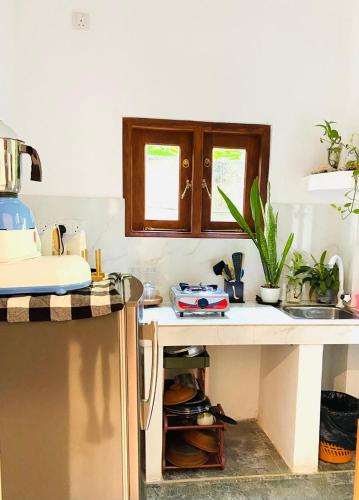a kitchen with a sink and a counter top at Diamond Key Ahangama in Piyadigama