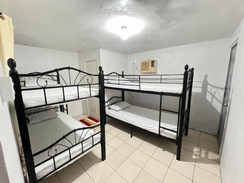 a bedroom with two bunk beds in a room at Resort safari hot spring in Calamba